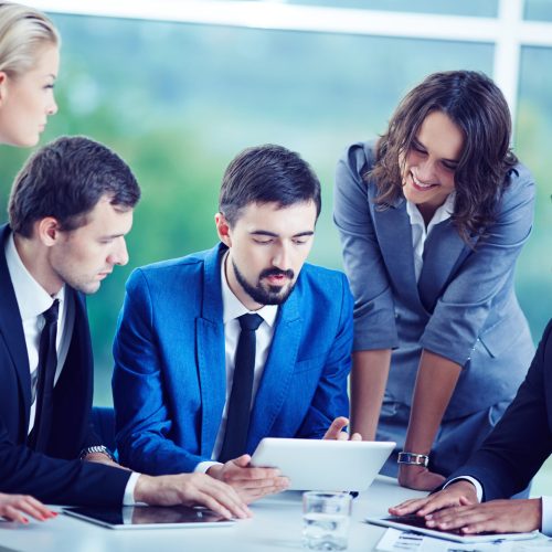 Several confident employees gathered at workplace discussing data
